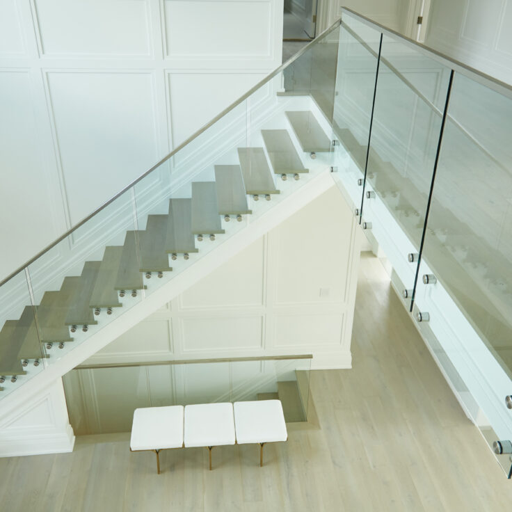 Above floating staircase with frameless glass railing