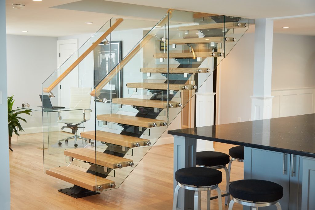 floating staircase with glass railing in modern home