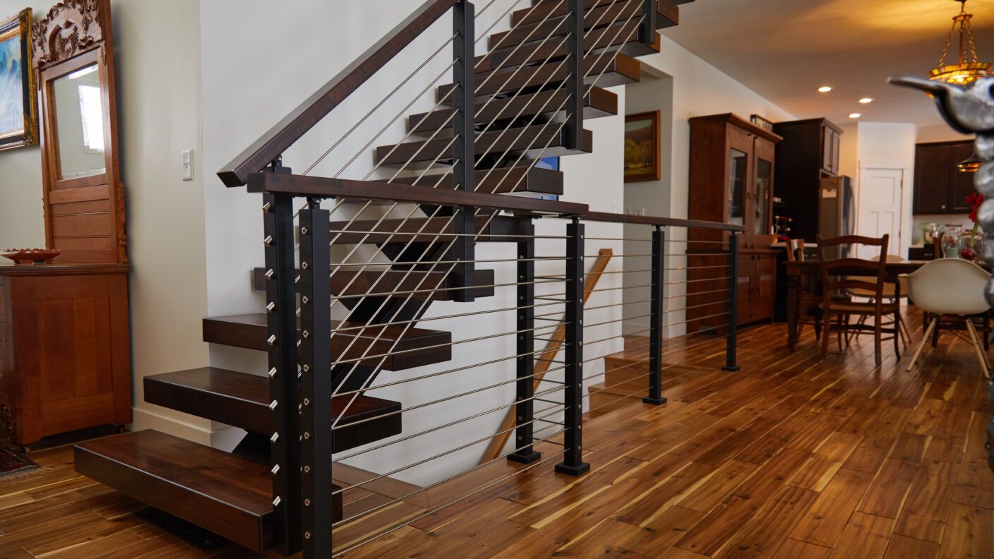 Floating stairs featuring hard maple treads with rod railing and a rod railing guard rail.