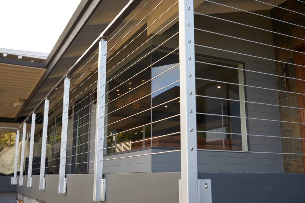 Stainless steel, side mounted cable railing on a modern deck