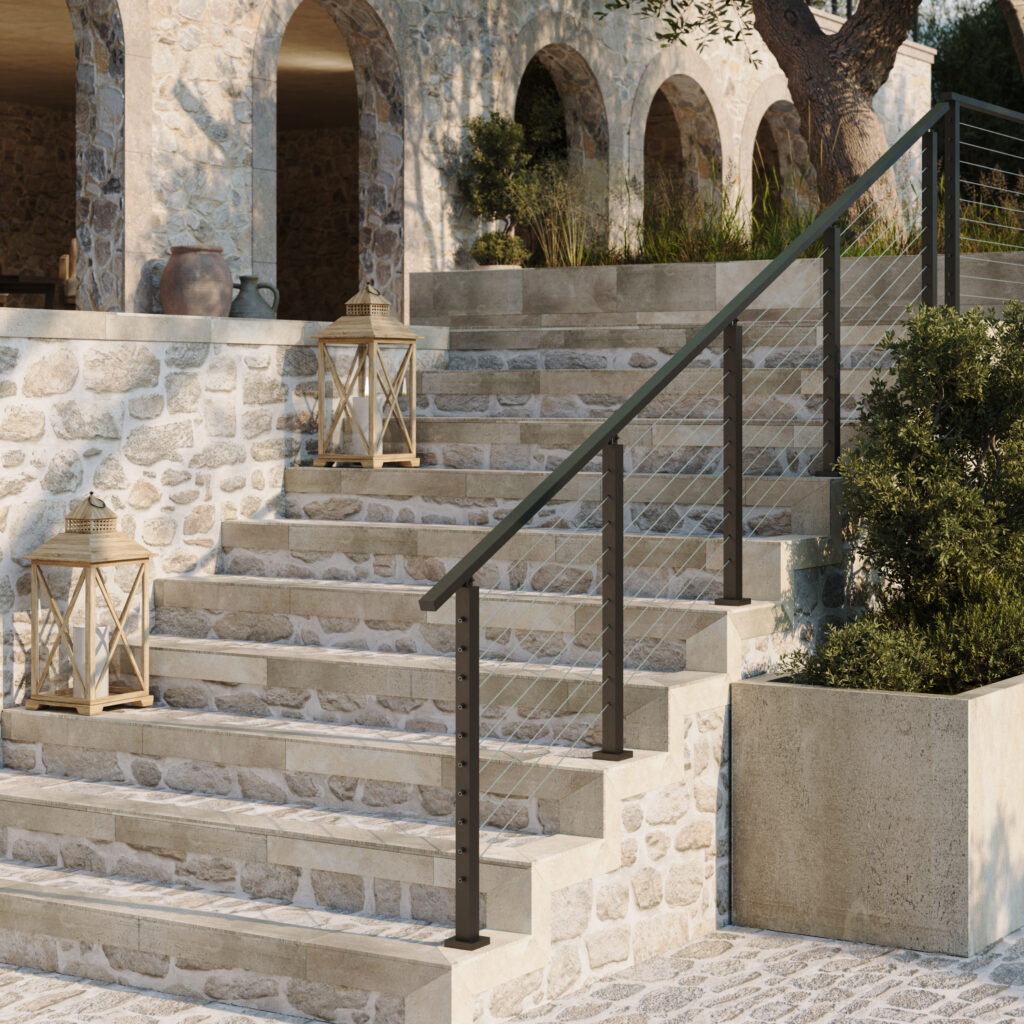 Black cable railing on a rustic stone staircase