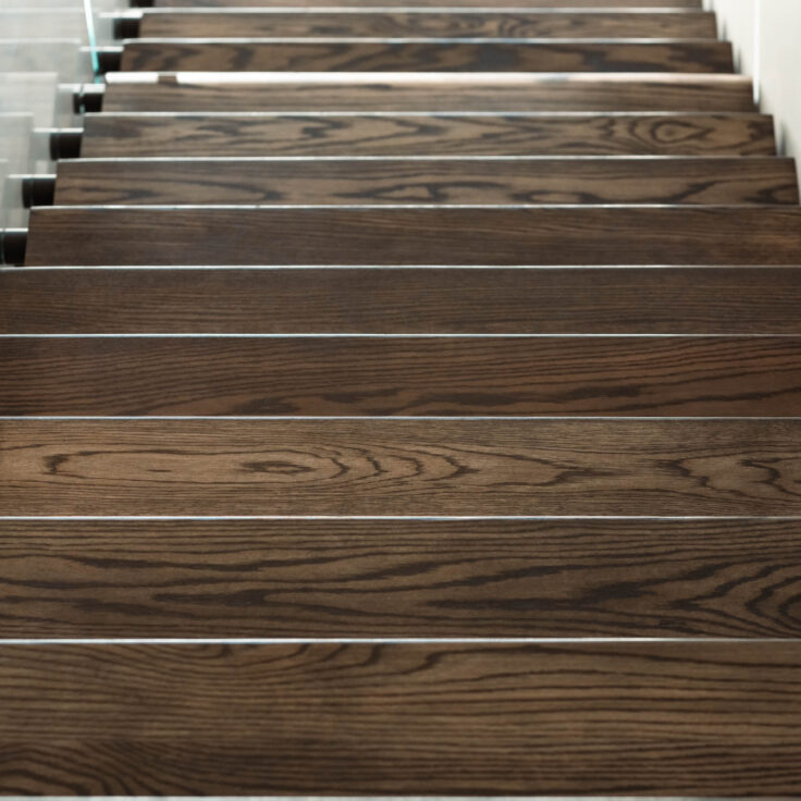 Dark Stained Wooden Stair Treads with Glass Railing