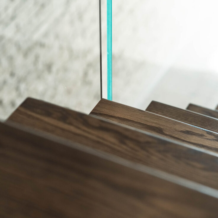 Dark Stained Wooden Stair Treads with Glass Railing