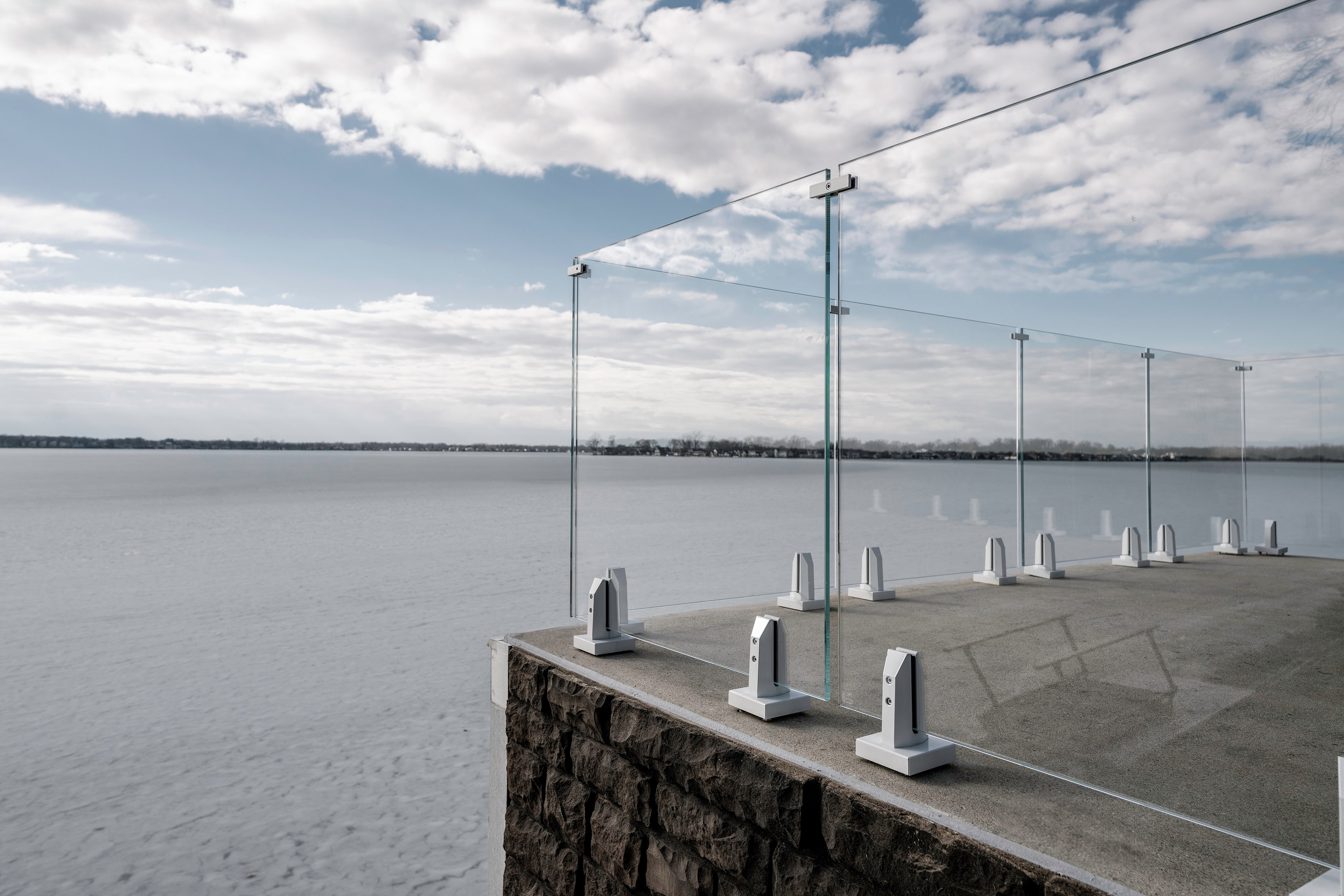 Glass Railing with White Accents looking over a Frozen Lake