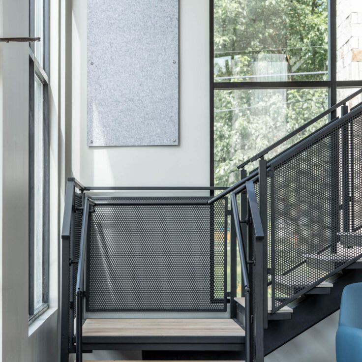 Floating Stairs made from Porcelain Treads and Perforated Railing Panels