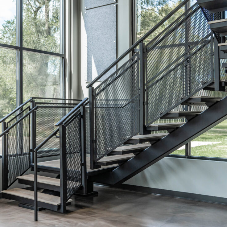 Floating Stairs made from Porcelain Treads and Perforated Railing Panels